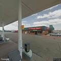 Person having cardiac issues near gas station sign