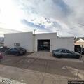 Suspicious person near open shop door on West Fifth