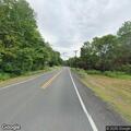 Elderly man walking across Route 2 in Erving