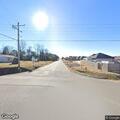 Traffic stop on white pickup at highway intersection