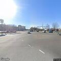 Person panhandling in road median near mall