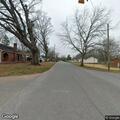 Man digging through trash from pickup in roadway