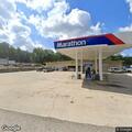 Traffic stop on blue Ford SUV at gas station