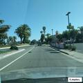 Person with back pain at hotel in Oceanside