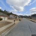 Four masked men walking through subdivision