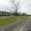 Fallen tree blocks Reynolds Road near power pole