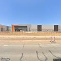 Man sleeping on truck at abandoned business