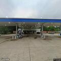 Officer checks vehicle at gas station