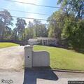 Abandoned gray sedan creating traffic hazard