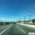 Pedestrian walking on freeway shoulder