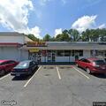 Person experiencing chest pain at shopping center bus stop