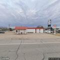 Suspicious person pacing in empty lot near Texaco