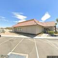 Person experiencing back pain outside Denny's