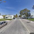 Man carrying bag of clothes in neighbor’s yard