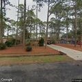 Person experiencing back pain at East Pine Court