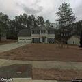 Female experiencing breathing and stomach issues at home