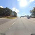 Person with shopping cart in road median