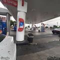 Suspicious white Nissan SUV stopped at gas pump
