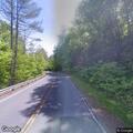 Officer checks smoking-brake tree truck on hill
