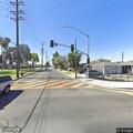 Two adults take water from open manhole at Pico Park