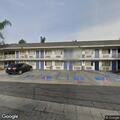 Couple arguing outside motel parking lot