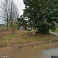 Woman yelling in yard at Pine Circle home