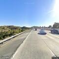 Pedestrian standing in highway center divide
