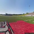 Person suffering heat exposure at university stadium entrance