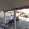 Men repeatedly search dumpster behind store