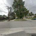 Man holding woman by neck behind Laurel Avenue business