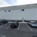 Officer checks gravel hazard near warehouse