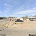 Woman with firearm at auto shop on West Main