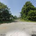 Tree limb on power line blocks part of roadway