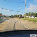 Officer checks vehicle at store parking lot