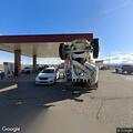Person slumped over in vehicle at gas station