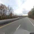 White car driving in middle of southbound lanes