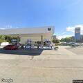Vehicle occupants smoking from pipe at gas station