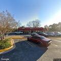 Person lying in parking lot after bike fall at store