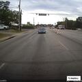 Blue Toyota Corolla stopped at auto parts store