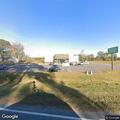 Officer checks parked vehicle at Dollar General
