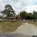 female holding arm seeks medical help near Magnolia