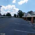 Suspicious person digging with knife behind business