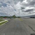 Motorcycle circling highway near auto property