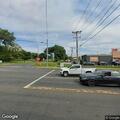Vehicle driving with rear hatch open near Elm Street