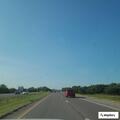 Semi with flatbed trailer driving erratically on I-35