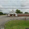 Man shouting at church while holding signs
