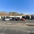 Reckless driver in dark two-door sedan near tire shop