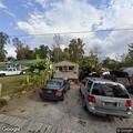 People in small car damaging trailer at home