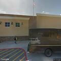 Elderly handicapped man working on white SUV at Walmart