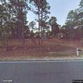 Brush fire spreading up tree on NC 73 highway